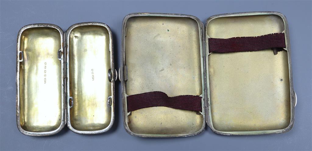 A silver cigarette case and a Victorian silver cheroot holder, 79mm.